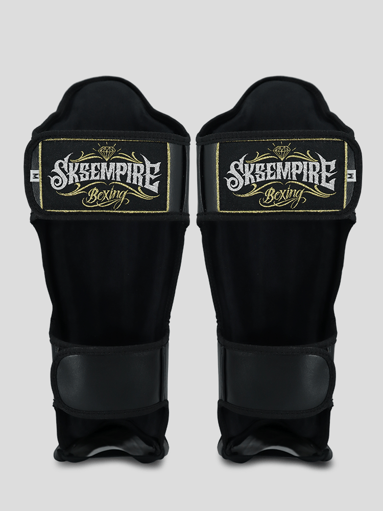 SKS Empire Schienbeinschoner - Sak Yant - Echtes Leder - Schwarz / Gold